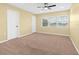 Cozy carpeted bedroom features a ceiling fan, a window with blinds and neutral tones for relaxation at 9780 Allen Rd, Lithia, FL 33547
