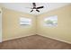 Sunny bedroom with two windows and neutral-colored carpeting at 9780 Allen Rd, Lithia, FL 33547