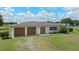 Charming single-story home featuring an attached two-car garage and manicured front lawn at 9780 Allen Rd, Lithia, FL 33547