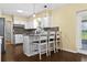 Kitchen with granite countertops, white cabinets, breakfast bar, and stainless steel appliances at 9780 Allen Rd, Lithia, FL 33547