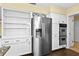 Bright kitchen with stainless steel appliances and custom cabinets and refrigerator at 9780 Allen Rd, Lithia, FL 33547