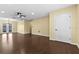Bright living room with a ceiling fan, wood-look floors, and ample natural light from the sliding door at 9780 Allen Rd, Lithia, FL 33547