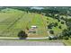 Aerial view outlining the property boundaries and highlighting the riding area, stall area, and expansive pastures at 9780 Allen Rd, Lithia, FL 33547