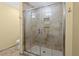 Walk-in shower with tiled walls, a glass door, and recessed shelving, creating a spa-like experience at 9780 Allen Rd, Lithia, FL 33547