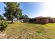 The backyard includes a spacious lawn and screened-in patio, ideal for entertaining or enjoying the outdoors at 3254 Great Neck St, Port Charlotte, FL 33952