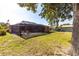 Expansive backyard with a screened-in patio area and lush green lawn, perfect for outdoor activities and relaxation at 3254 Great Neck St, Port Charlotte, FL 33952