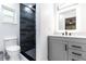 Renovated bathroom featuring modern vanity, countertop, toilet, and tiled walk-in shower with black fixtures at 3254 Great Neck St, Port Charlotte, FL 33952