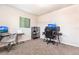 Bright bedroom with computer desks, chairs, carpeted floor, and sports memorabilia at 3254 Great Neck St, Port Charlotte, FL 33952