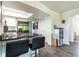 Kitchen with granite countertops, breakfast bar, stainless steel appliances, and wood-look flooring at 3254 Great Neck St, Port Charlotte, FL 33952