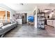 Open floor plan with living room featuring wood floors, access to kitchen and backyard, and modern decor at 3254 Great Neck St, Port Charlotte, FL 33952