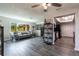 Bright living room with wood floors, modern gray sofa, and easy access to kitchen at 3254 Great Neck St, Port Charlotte, FL 33952
