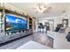 Open-concept living room with wood floors, a large TV, and a comfortable gray sectional at 3254 Great Neck St, Port Charlotte, FL 33952