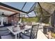 This covered patio includes an outdoor kitchen, dining area, and comfortable seating for relaxing or entertaining guests at 3254 Great Neck St, Port Charlotte, FL 33952