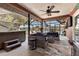 Screened-in patio with comfortable wicker furniture, ceiling fan, and hot tub at 3254 Great Neck St, Port Charlotte, FL 33952