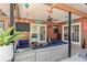 Outdoor covered patio area with wicker furniture, ceiling fan, and access to the backyard at 3254 Great Neck St, Port Charlotte, FL 33952