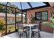 Outdoor patio with a table, four chairs, and a view of the backyard at 3254 Great Neck St, Port Charlotte, FL 33952