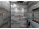 Modern tiled shower featuring gray tiles, black fixtures, a shower niche, and a hand shower at 3254 Great Neck St, Port Charlotte, FL 33952