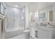 Elegant bathroom features a marble-clad shower, a white vanity, and modern fixtures at 1010 Central Ave # 227, St Petersburg, FL 33705
