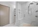Modern bathroom featuring a marble tiled shower with glass door, bench, and built-in shelving at 1010 Central Ave # 227, St Petersburg, FL 33705