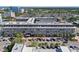 A multi-story building featuring a gray facade, balconies, and street parking, complemented by palm trees and sidewalks at 1010 Central Ave # 227, St Petersburg, FL 33705
