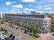 The exterior features balconies, palm trees, and sidewalks, with a modern gray facade and parking spaces at 1010 Central Ave # 227, St Petersburg, FL 33705