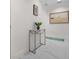 Bright hallway with marble floors, decorative console table, and stylish artwork, enhancing the interior aesthetic at 1010 Central Ave # 227, St Petersburg, FL 33705