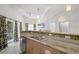 Open kitchen area with granite countertops, stainless steel dishwasher, and view to living room and balcony at 1010 Central Ave # 227, St Petersburg, FL 33705