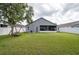 Spacious backyard featuring a screened lanai and a charming swing set near a mature shade tree at 10811 Lakeside Vista Dr, Riverview, FL 33569