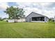 Backyard featuring lush grass and a partially screened-in patio at 10811 Lakeside Vista Dr, Riverview, FL 33569