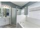 Bathroom featuring soaking tub with glass enclosed shower and single sink at 10811 Lakeside Vista Dr, Riverview, FL 33569