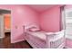 Pink bedroom featuring a single bed, closet, and view of the outside at 10811 Lakeside Vista Dr, Riverview, FL 33569