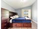 Comfortable bedroom with custom built-ins and view of the lake at 10811 Lakeside Vista Dr, Riverview, FL 33569
