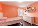 Bright bedroom featuring white furniture, wood floors, and fun wall decor and shelving at 10811 Lakeside Vista Dr, Riverview, FL 33569