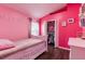 Pink bedroom featuring a single bed, closet, and desk at 10811 Lakeside Vista Dr, Riverview, FL 33569
