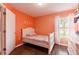 Cozy bedroom featuring wood floors, ample natural light, and a white door at 10811 Lakeside Vista Dr, Riverview, FL 33569
