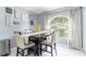 Cozy dining area boasts a large arch window with decorative wall art and a view of the lush greenery outside at 10811 Lakeside Vista Dr, Riverview, FL 33569