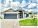 Charming single Gathering home with a two-car garage, front yard, and well-maintained landscaping at 10811 Lakeside Vista Dr, Riverview, FL 33569