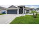 Charming single Gathering home with a two-car garage, front yard, and well-maintained landscaping at 10811 Lakeside Vista Dr, Riverview, FL 33569