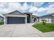 Charming single Gathering home with a two-car garage, front yard, and well-maintained landscaping at 10811 Lakeside Vista Dr, Riverview, FL 33569
