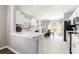 Bright kitchen featuring white cabinetry, stainless steel appliances and a charming dinette area with large arch window at 10811 Lakeside Vista Dr, Riverview, FL 33569