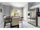 Bright dinette area features stainless steel appliances, including a refrigerator and view of the backyard at 10811 Lakeside Vista Dr, Riverview, FL 33569