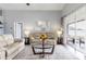 Cozy living room features hardwood floors, access to the lanai, and comfortable seating at 10811 Lakeside Vista Dr, Riverview, FL 33569