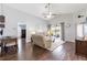 Open-concept living room featuring hardwood floors, vaulted ceilings and patio doors to the outdoor lanai at 10811 Lakeside Vista Dr, Riverview, FL 33569