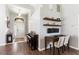 Open-concept living room with sleek wood flooring, work space, and a bright entryway at 10811 Lakeside Vista Dr, Riverview, FL 33569
