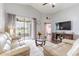 Comfortable living room features a vaulted ceiling, hardwood floors and access to the outdoor living space at 10811 Lakeside Vista Dr, Riverview, FL 33569