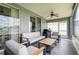 Comfortable screened-in patio offering lounge seating, ceiling fan, and views of the lake at 10811 Lakeside Vista Dr, Riverview, FL 33569