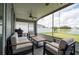 Relaxing screened-in patio with lake views and comfortable seating area at 10811 Lakeside Vista Dr, Riverview, FL 33569