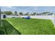 Spacious backyard with artificial turf, play equipment, and full privacy fence at 10954 96Th St, Largo, FL 33773