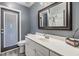 Gray bathroom featuring a large vanity with a framed mirror and a toilet at 10954 96Th St, Largo, FL 33773