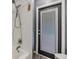 Clean white bathroom shower with a handheld shower head and glass door at 10954 96Th St, Largo, FL 33773